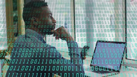 IT worker sitting desk by window, gazing at laptop and analyzing data with green Stock Footage 333351502