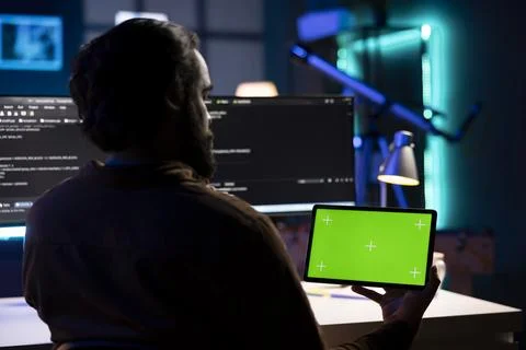 IT worker testing and debugging code for applications on mockup tablet Stock Photos