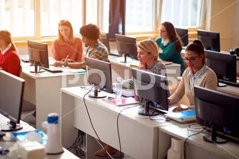 IT workshop at university. Group of Students on class with computer. Stock Photos