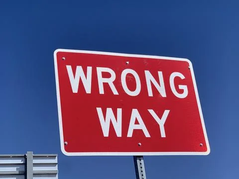 It the "Wrong way" sign post Stock Photos