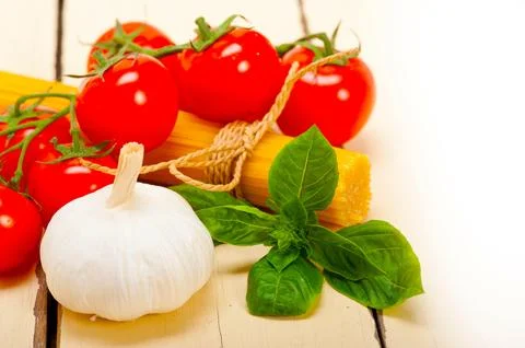 Italian basic pasta fresh ingredients cherry tomatoes garlic and basil Stock Photos