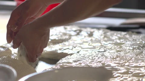 Italian cheese-maker makes mozzarella Stock Footage 46177439