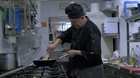 Italian Chef Cooking In A Restaurant Kitchen In Rome, Italy Stock Footage 155007053