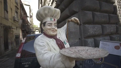 Italian chef puppet with price table with gimbal at a tiny street Stock Footage 71219643