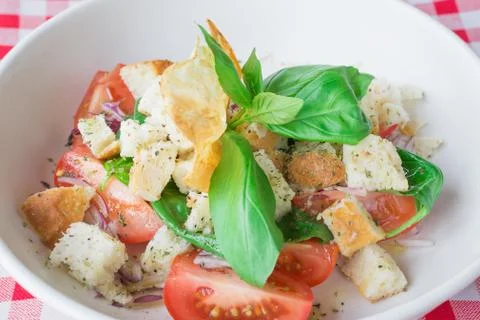 Italian cuisine, delicious vegetarian salad with croutons, tomatoes, lettuce Stock Photos