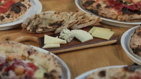 Italian Dinner Table with Neapolitan Pizzas and Cheese Board Stock Footage 340862595