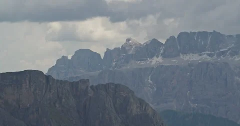 Italian dolomites mountain range landscape under cloudy sky Видео 340779920