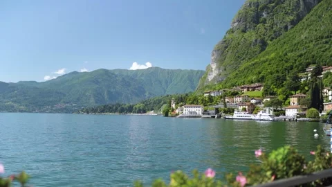 Italian ferry port at Como Lake on sunny day with mountains Stock Footage 276681153