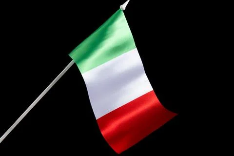 The Italian flag on a black background developing and waving in the wind Stockfoto's