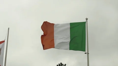 Italian flag in the wind in cloudy blue sky in Deauville Beach, France. Low Stock Footage 119344072