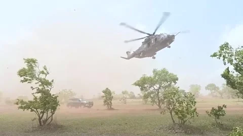 Italian Forces HH-101A Caesar helicopter hovering in desert Stock Footage 276163712