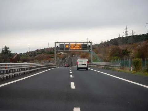 Italian highway driving with variable message sign displaying road works wa.. 스톡 사진
