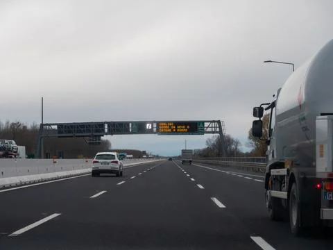 Italian highway with variable message sign indicating obligation for winter.. Fotos de archivo