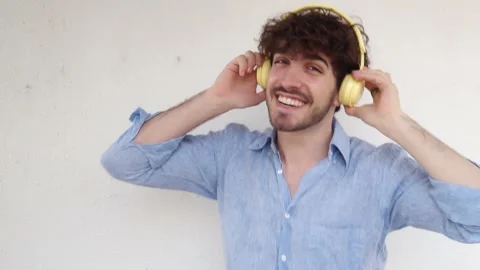Italian man dancing laughing while listening to music with headphones. Funny man Stock Footage 207182582