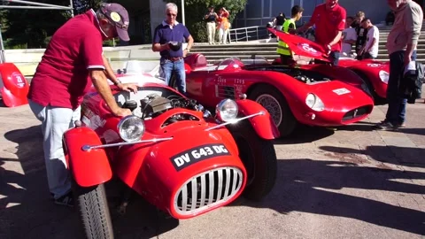 Italian owner maintaining the engine of the Red Formula sports racer car. Stock Footage 322134069