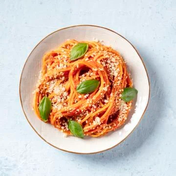 Italian pasta. Spaghetti with tomato sauce, cheese and basil, overhead square Stock Photos