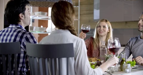 Italian people making toast together with red wine. Four happy real candid Stock Footage