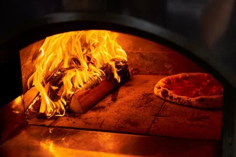 Italian pizza is cooked in a wood-fired oven Stock Photos