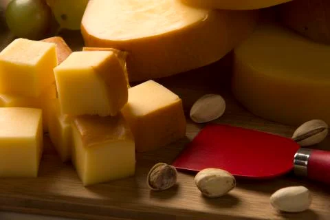 Italian provolone on wooden board Stock Photos