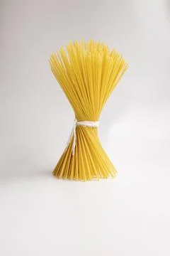 Italian raw spaghetti close-up. Vertically. On a white background. Italian cu Stock-Fotos
