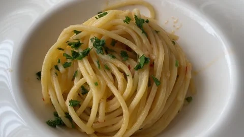 Italian spaghetti aglio olio e peperoncino pasta with parsley. Stock Footage 345969121
