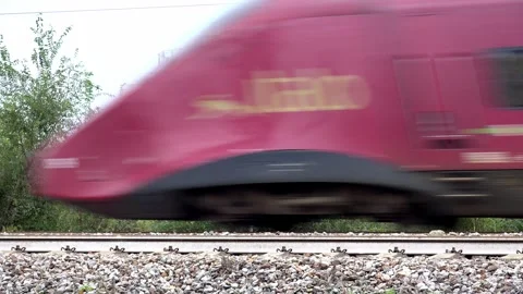 Italo train running in front of a gasometer - C0017 Stock Footage 290849641