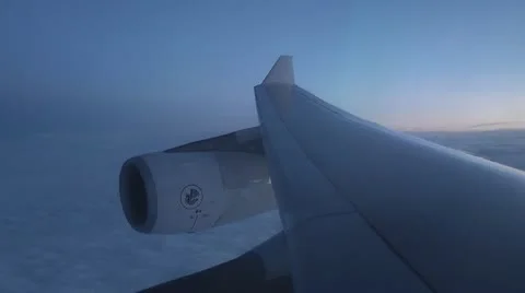 ITALY-0019 JET ENGINE AND WING FLYING OVER CLOUDS AT DUSK Stock Footage 11814129