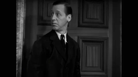 ITALY - 1932 - in this comedy, a servant knocks on a woman's door and asks where Stock Footage 330604096