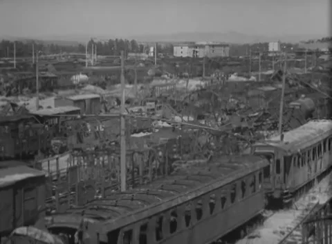 ITALY - 1944: Rail yard - Freight wagons fill parallel sidings above a city Stock Footage 344485776
