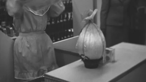 Italy - 1960s: cashier puts an easter egg into a box at the supermarket Stock Footage 155155694