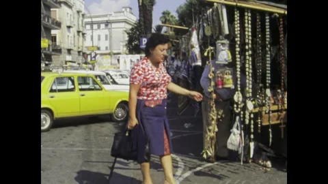 Italy 1975, Curious Woman Observing Souvenir Stall in 1970s Naples: Nostalg.. Stock Footage 242323273