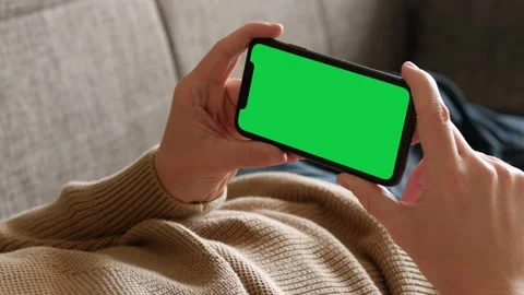 Italy - 2022: Single Tapping and Holding a Green Screen iPhone Stock Footage 227514574