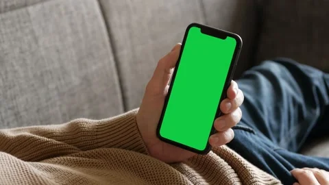 Italy - 2022: Single Tapping and Holding a Green Screen iPhone Stock Footage 227514733