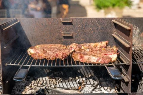 Italy. Beef steaks on the barbeque ready to serve and eat. Stock Photos