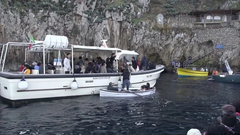 ITALY CAPRI THE BLUE GROTTO GROTTA AZURRA TURISTS WOODEN ROWBOAT Stock Footage
