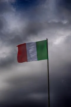 Italy flag and dramatic clouds. Stock Photos