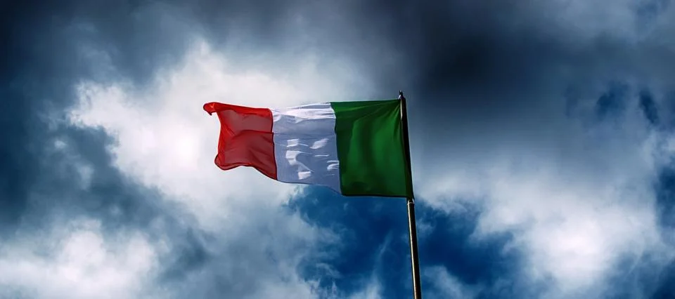 Italy flag and dramatic clouds. Stock Photos