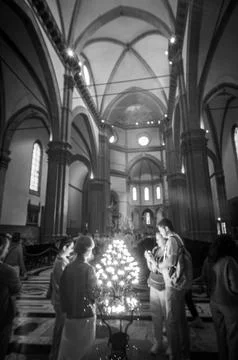 Italy Florence, 2026-04-20 - People Observing a Candlelit Display Inside Florenc Stock Photos
