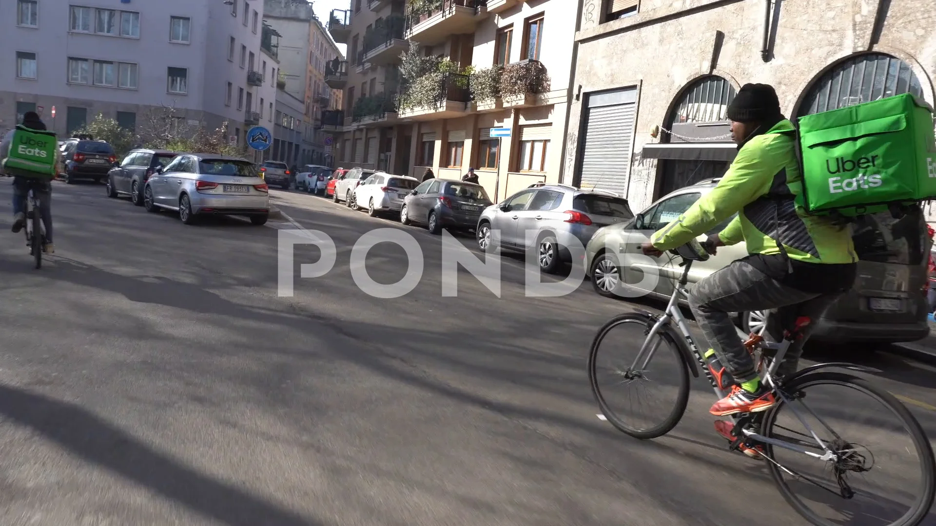 Italy , Milan January 21,2020 - Uber eats delivery food - bike driver going  in a