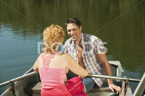 Italy, South Tyrol, Couple in rowing boat, smiling, portrait Stock Photos