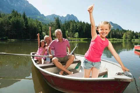 Italy, South Tyrol, Grandparents and children (6-7) (8-9) in rowing boat on Stock Photos