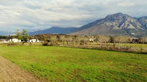 Italys Mountains behind fields on a cloudy day. Stock Footage 137780404