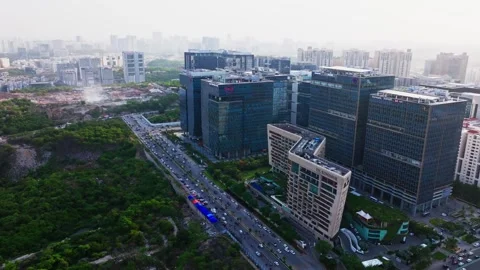 ITC Kohenur with glass facade building, greenery, traffic flow and haze at Video stock 342279976