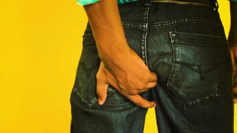 Itching buttocks - Causes of butt rashes in adults . Young man rude scratches Stock Footage 141374784