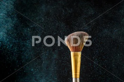 Item makeup - brush on black background with eye shadows Stock Photos