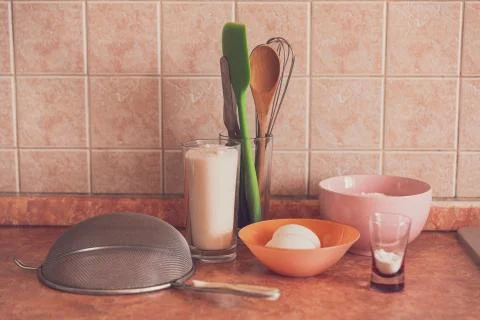 Items and products for making a cake on the table in an ordinary kitchen. Stock Photos