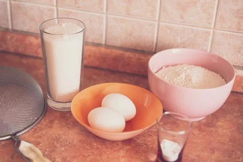 Items and products for making a cake on the table in an ordinary kitchen. Stock Photos