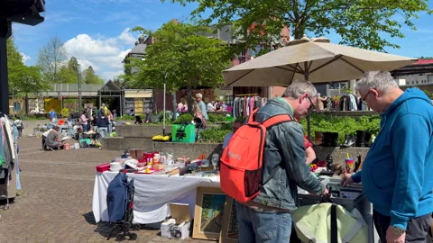 Items are being examined at the Lörrach flea market Stock Footage 336097756