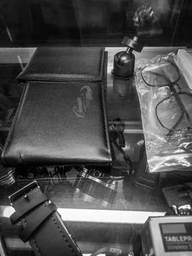 Items inside a glass display case in a shop, black and white Stock Photos