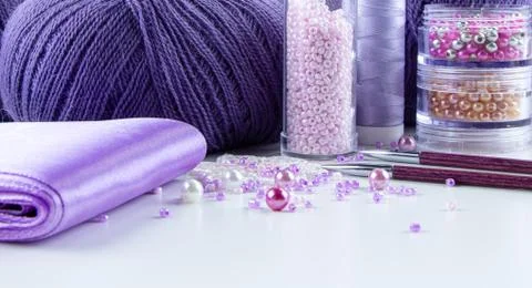 Items for needlework and creativity in pink and purple colors. Stock Photos